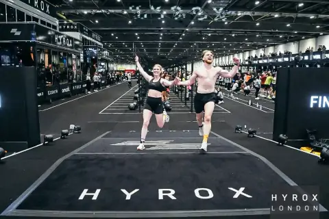 Lewis and Charlotte crossing the Hyrox London finish line
